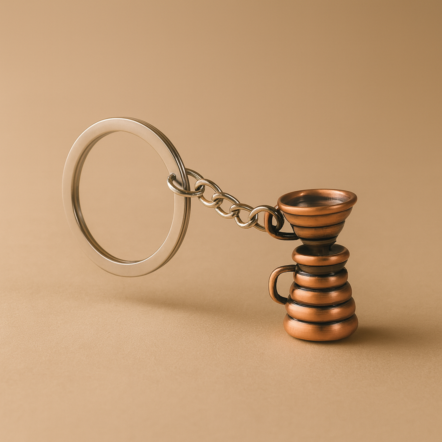 Bronze spiral keychain on a beige background