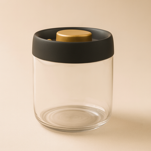Clear glass jar with black lid and wooden top on a beige background