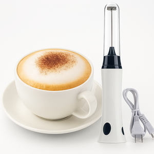 White cup of cappuccino with a milk frother on a white background