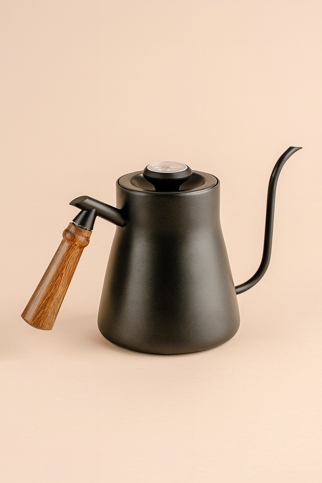 Black kettle with wooden handle on beige background